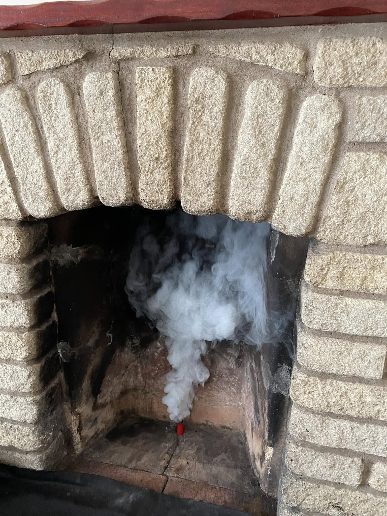 A smoke test under way in a stone fireplace