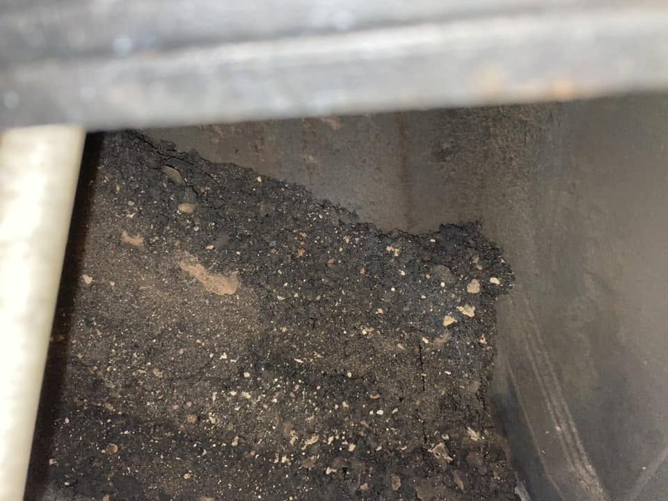 A heap of soot swept down into a fireplace